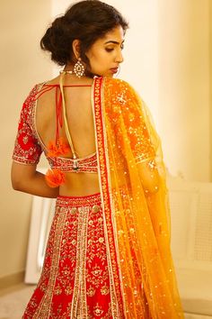 Red blouse with zardozi embroidered floral motifs. Paired with matching kalidar lehenga and sequin dupatta.
Components: 3
Fabric: Raw silk
Neckline: Round
Sleeve Length: Half
Color: Red
Embroidery
Low back with tie up and tassels
Dupatta with embroidered border and tassels
Closure: 
Blouse: Hook back
Lehenga: Side tie up with tassels - Aza Fashions Red Dola Silk Sharara With Mirror Work, Red Anarkali Lehenga With Mirror Work, Red Lehenga With Mirror Work And Traditional Drape, Festive Red Lehenga With Mirror Work, Red Lehenga With Dori Work For Navratri, Red Choli For Navratri With Kundan Style, Red Lehenga With Mirror Work For Diwali, Festive Red Lehenga With Dori Work, Bollywood Red Choli With Mirror Work