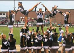 a group of cheerleaders standing on top of each other