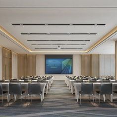 an empty conference room with tables and chairs set up for a meeting or presentation on the screen