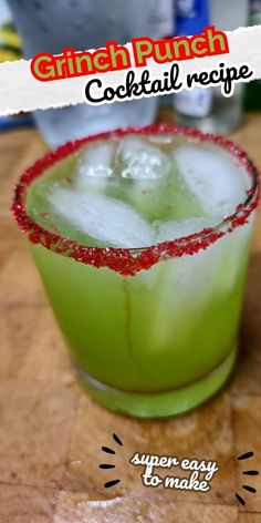 a green cocktail with red sprinkles on the rim