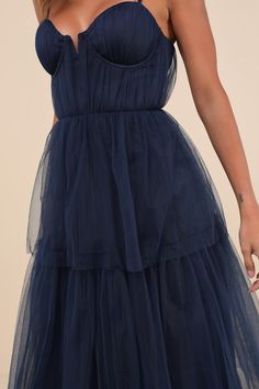 Making it an evening to remember is simple with a grand look like the Lulus Unforgettable Poise Navy Blue Tulle Bustier Tiered Maxi Dress! Airy, sheer tulle-mesh fabric shapes a bustier-style bodice with lightly gathered detailing throughout, padded cups with supportive underwire, and a sweetheart neckline (with a notched V-bar at the center), all supported by adjustable spaghetti straps. The high, fitted waist tops a tiered maxi skirt with a ballgown-inspired silhouette that will gracefully swe Blue Tulle Dress, Navy Maxi Dress, Tiered Maxi Skirt, Dress Tulle, Blue Tulle, Maxi Dress Navy, Tiered Maxi Dress, Tulle Dress, Mesh Fabric