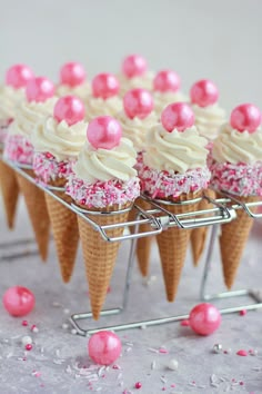 some ice cream cones with pink sprinkles on them