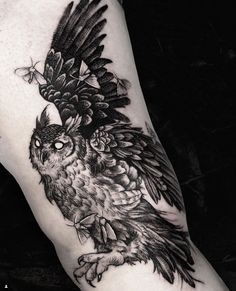 a black and white photo of an owl tattoo