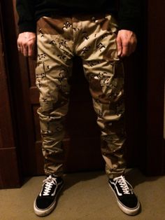 These are authentic BDU desert camouflage pants that I tailor for a more stylish fit.  Since these are authentic BDU pants, the sizes are unconventional in that they have adjustable waist tabs.  The pictured model typically wears a size 30 x 32.  He is wearing a size Medium Regular with the leg opening tapered to 7 inches flat.   If you have any questions or would like a more personalized fit, please message before ordering! - - - - - - - - - - - - - - - - - - - - - - - - - - - - - - - - - - - - - - - Here is a breakdown of the waist by length sizing: Small Regular:  27 - 30 x 32 Medium Regular:  31 - 34 x 32 Large Regular:  35 - 38 x 32 Extra Large Regular:  39 - 41 x 32 Fitted Combat Bottoms With Cargo Pockets, Military Style Camouflage Straight Leg Pants, Military Camouflage Straight Leg Pants, Fitted Camouflage Cargo Pants, Fitted Military Style Pants For Streetwear, Fitted Camouflage Military Pants, Combat Camouflage Bottoms With Multiple Pockets, Fitted Camouflage Cargo Pants For Streetwear, Military Style Fitted Bottoms For Streetwear