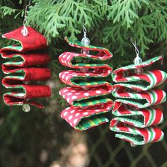 three christmas ornaments hanging from a tree