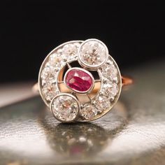 Year: 1900s Item Details: Ring Size: 4.5 (Sizable) Metal Type: 14K Yellow Gold and Platinum Top [Hallmarked, and Tested] Weight: 4.5 grams Ruby Details: .35ct, Natural, Red, Unheated, Elongated Antique Cushion Shape. Diamond Details: 2 Old European Cut Diamonds at .45ct each and 8 Additional Old Mine Brilliants weighing a total of .15ct. Total diamond weight is 1.05ct. Band Width: 1.73 mm Condition: Excellent Edwardian This ring can be sized up or down 4 sizes for an additional $40. If you wish Platinum Ruby Ring With 17 Jewels, Victorian Ruby Ring With Center Stone, Victorian Diamond Ring With 17 Jewels, Antique Oval Hallmarked Diamond Ring, Art Deco Cluster Ring With 17 Jewels, Antique Hallmarked Diamond Ring, Victorian Ruby Ring With Rose Cut Diamonds, Vintage Hallmarked White Gold Ruby Ring, Antique Platinum Ring With Gemstone