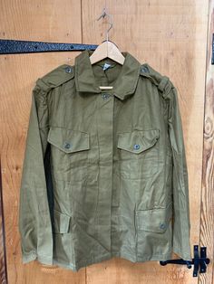 Herring bone twill (HBT)light field jacket  Even has a spare materiel swatch and button in the pocket  more brown khaki then green Has had a badge removed from the army but no signs of use  Fastens right to left with buttons 23" across the chest  27" back length  16" inner arm Olive Utility Jacket With Flap Pockets, Olive Long Sleeve Utility Jacket With Flap Pockets, Olive Military Outerwear With Patch Pockets, Military Style Button-up Utility Jacket With Pockets, Military Style Khaki Outerwear With Multiple Pockets, Military Style Long Sleeve Khaki Utility Jacket, Khaki Military Outerwear With Multiple Pockets, Green Utility Jacket With Cargo Pockets For Workwear, Olive Utility Jacket With Cargo Pockets