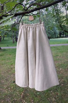 Your Story is a linen midi wide skirt with pockets, and a stitching elastic band at the waist (thanks to that the elastic band will not roll out after washing). The skirt has two comfortable pockets. Your Story is a classic. You can wear it with sneakers for everyday outings, and combined with boots or high heels, it will be used as a creation for more occasional outings. Linen is highly resistant, does not stretch or tear, does not pill, does not electrify, and becomes softer and smoother after Beige Linen Maxi Skirt For Spring, Beige Linen Bohemian Skirt, Bohemian Beige Linen Skirt, Bohemian Beige Skirt With Pockets, Beige Linen Flared Maxi Skirt, Beige Linen Wide Leg Maxi Skirt, Beige Flared Linen Maxi Skirt, Linen Midi Maxi Skirt With Gathered Details, Beige Linen Flared Skirt