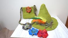 "Felted Snufkin inspired hat - perfect festival, holiday or sauna accent! Hat can be decorated with crochet cord, flower pins and peacock or colorful feather - according to your choice. Flower pins can be used with your other outfit. You can select decor and color (green tones are presented on the last photo) of the hat. Please convo me about flower or feather colors or flower quantity, if other than 3 or if you want to have few options of decor with one hat. You can indicate size, otherwise I w Whimsical Handmade Green Hat, Whimsical Handmade Felt Costume Hats And Headpieces, Whimsical Handmade Costume Hats And Headpieces As Gift, Whimsical Green Costume Hats For Festivals, Whimsical Green Costume Hats And Headpieces For Festival, Handmade Whimsical Felt Hat, Whimsical Green Festival Costume Hats And Headpieces, Whimsical Green Festival Hat, Whimsical Green Mini Hats