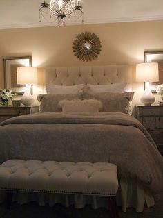 a bedroom with a large bed and chandelier