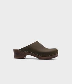 low heeled minimalistic clog mules in olive nubuck leather stapled on a dark wooden base Cork Sandals, Wooden Clogs, Timeless Aesthetic, Clog Sandals, Leather Clogs, Day To Night, To Night, Nubuck Leather, Boot Shop