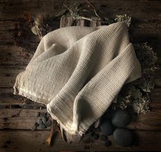 an image of some rocks and plants on the ground with a cloth over it that is laying on top of them