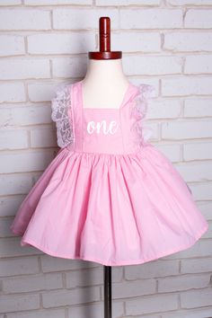 As a professional photographer I loved the poofy dresses for 1st birthday photos but hated cleaning the tulle.  This dress is made of cotton so it is easier to wash and use again, whether for everyday use or for a special cake smash session. This handmade dress is pink with pink lace trim and perfect for that fairy or princess on the go!  It is made with cotton allowing her  the ability to have fun as well as washable for the grown ups. Included are a pair of pink romper shorts as well as a detached cotton white petticoat skirt to add volume.   Dress is fully lined. If choosing a different color the bloomers will be the same color as the dress. This dress can be made in sizes 12 months to 14 years. For customization simply choose from the font/words you want from the gallery.  In the custo Poofy Dresses, Poofy Dress, Pink Romper, Romper Shorts, 1st Birthday Photos, Birthday Girl Dress, Handmade Dress, Pink Rompers, Special Cake