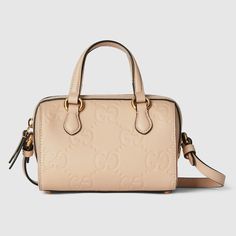 Find GUCCI Gg Super Mini Top Handle Bag on Editorialist. The Gucci GG Super Mini Top Handle Bag is crafted from light beige GG leather. The bag features a top handle with a 3.1 inch drop, a detachable shoulder strap with a 22.4 inch drop, and a zip closure. The bag measures 6.3 inches wide, 4.3 inches high, and 3.5 inches deep. It is made in Italy and weighs approximately 0.70 lbs. The bag also includes an external compartment and a cotton linen lining. The bag is designed to fit an iPhone Pro/P Gucci Handheld Shoulder Bag For Everyday Use, Gucci Crossbody Satchel With Top Carry Handle, Gucci Handheld Bag With Detachable Handle, Gucci Shoulder Bag With Top Carry Handle, Gucci Crossbody Satchel, Gucci Handheld Shoulder Bag With Detachable Handle, Everyday Handheld Gucci Satchel, Gucci Satchel Shoulder Bag, Gucci Satchel Shoulder Bag With Handles