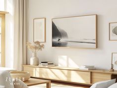 a living room filled with furniture and pictures on the wall above it's coffee table