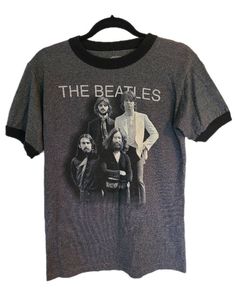 Cool find! Just like new The Beatles charcoal grey ringer style tshirt. Like new condition! Size: MENS SMALL Tri-blend T-shirt With Band Logo And Crew Neck, Tri-blend Crew Neck T-shirt With Band Logo, Gray Band Merch T-shirt With Crew Neck, Gray Band Merch Crew Neck T-shirt, Gray Crew Neck Band Merch T-shirt, Retro Tri-blend Black T-shirt, Retro Black Tri-blend T-shirt, Retro Gray Letter Print T-shirt, Retro Gray T-shirt With Screen Print