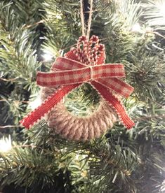 a wreath ornament hanging from a christmas tree