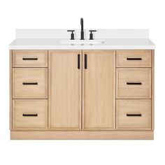 a white sink sitting under a wooden cabinet