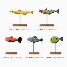 four different types of fish on wooden bases