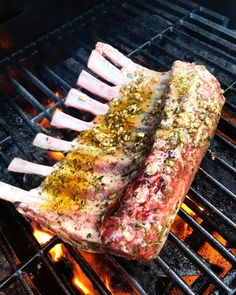 two steaks are cooking on the grill with some seasoning sprinkles