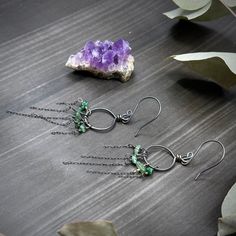 These earrings were created with emerald chips and sterling silver. I created the hoops out of 18 gauge sterling silver, and I created the earwires out of 20 gauge sterling silver.These earrings are 3” long at the longest point and each one weighs 1.4 grams. Green Wire Wrapped Dangle Hoop Earrings, Green Wire-wrapped Dangle Hoop Earrings, Green Sterling Silver Small Hoop Jewelry, Green Small Hoop Sterling Silver Jewelry, Green Sterling Silver Hoop Earrings For May Birthstone, Sterling Silver Hoop Earrings For May Birthstone, Nickel-free Green Sterling Silver Hoop Earrings, Green Sterling Silver Small Hoop Earrings, Green Long Drop Sterling Silver Jewelry