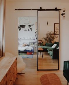 a living room filled with furniture and a sliding glass door that leads to a bedroom