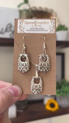 a pair of earrings is shown in front of a card