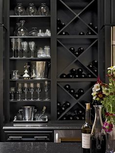 a wine rack filled with lots of bottles and glasses