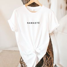 "By wearing this shirt, honor yourself and others with a NAMASTE greeting, expressing appreciation and respect. The meaning of the ancient Sanskrit word \"Namaste\" is - \"I honor the place in you in which the whole universe resides. I honor the place of love, light, and peace. We are one when you are in that place in you, and I am in that place in me.\" P.s. You may also like this design - https://www.etsy.com/listing/1327657465/namaste-unisex-organic-t-shirt-yoga?ref=listings_manager_grid USEFUL INFORMATION - This shirt is made just for you in a socially and environmentally safe way. Honor our planet a little bit by reducing your footprint with this eco-friendly Bella Canvas T-shirt!  - The printing process is eco-friendly, and the inks are water-based, biodegradable, and non-toxic. - De Relaxed Fit Yoga T-shirt With Letter Print, White Crew Neck Top For Meditation, White Spiritual Graphic T-shirt, Conscious White Crew Neck Top, White Conscious Crew Neck Top, White Crew Neck Top, Inspirational White T-shirt For Gift, Inspirational White T-shirt As Gift, Relaxed Fit T-shirt With Letter Print For Yoga