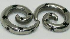 two metal spirals with stars on them