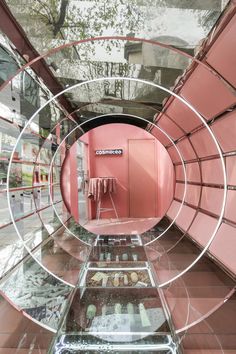 the inside of a pink room with mirrors