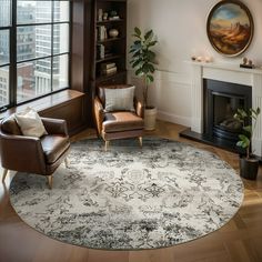 a living room with a large rug on the floor next to a chair and fireplace