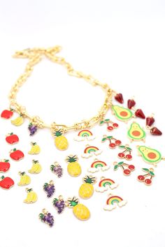 What's cheerier than fruits and rainbows? We've gathered together this delicious little bundle of enamel charms to brighten up your day. Choose your favorite fruit or a rainbow, or choose them all!These mix and match perfectly with our enamel chains and so many other beads. Use a jump ring to add these cheery charms onto a chain or beaded necklace for your daily dose of fruits and rainbows!✨The MAGIC is in the Details✨Charm Size: Apple: 10x15mmBanana: 8x12mmGrapes: 10x14mmPineapple: 10x24mmRainb Gift Multicolor Charm Necklace With Removable Charms, Playful Charm Necklace With Dangling Charms For Gift, Multicolor Charm Necklace With Removable Charms As Gift, Multicolor Charm Necklaces With Removable Charms As A Gift, Playful Rainbow Charm Necklaces For Gifts, Playful Rainbow Charm Necklace For Gift, Playful Rainbow Charm Necklace As Gift, Cute Multicolor Charms For Gifts, Cute Multicolor Jewelry With Removable Charms