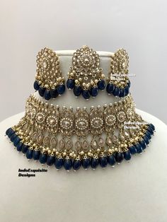 Antique Gold Polki Necklace Set comes with Stud earrings and tikka / Indian Jewelry/ High Quality Kundan and Polki Jewelry/ Bollywood Jewelry/Wedding Jewelry/Navy Blue  All items are shipped from Brampton, Ontario, Canada. If you need your item by a certain day, please reach out to us for express delivery option before placing the order so that we can update the shipping for you. Standard shipping/delivery timeline Below are the delivery timeline estimates once the order ia shipped ---> USA delivery timeline * 3-5 business days to major urban centers in USA. It may take 1-2 days extra to remote locations ---> Canada delivery timeline  * 2-3 business days - GTA  & Montreal  * 2-4  business days - Rest of Ontario/Quebec * 3-6 business days-  Rest of Canada    ---> Europe/Middle East timeline Diwali Party Jewelry With Zari Work, Bollywood Blue Bridal Necklace Hand Set, Blue Hand Set Necklace For Diwali, Heavy Blue Bridal Necklace For Diwali, Blue Kundan Bollywood Jewelry Sets, Blue Bollywood Jewelry Sets With Stone Work, Blue Kundan Bridal Necklace Hand Set, Bollywood Blue Stone Work Jewelry Sets, Blue Stone Work Jewelry For Celebration