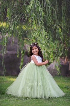 "Sweet simplicity! Our unique full and fluffy tulle dress feature a lined ivory satin sleeveless bodice with an OLIVE GREEN tutu style skirt. The back of the dress bodice is stretchy for a custom, yet versatile, comfort fit. Want a WHITE or OFF-WHITE (LIGHT IVORY) bodice instead. We can change these colors! WANT A SEWN IN SLIP TO LINE THE TUTU? https://www.etsy.com/listing/125566641/add-a-slip-to-the-tutu-dress-sewn-in At checkout, please give us the following information: HOW TO ORDER: IMPORTAN Green Flower Girl Dresses, Mint Green Flowers, Blush Flower Girl Dresses, Green Tutu, Dress Olive Green, Tulle Flower Girl Dress, Fluffy Skirt, Luxurious Dresses, Green Tulle