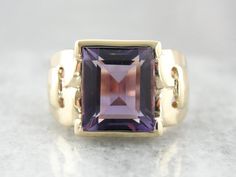 This stunning vintage ring features a luscious Amethyst center, square cut with a lot of glimmer! The simple mounting features beautiful filigree swirl cut-out shoulders that really make this unique and special! Metal: 10K Yellow Gold Gem: Amethyst 4.93 Carats Gem Measurements: 9.9 x 10.6 mm, Rectangle Ring Size: 7.75 Marks: "10K" Stamped on the inside band Elegant Rectangular Amethyst Ring For Formal Occasions, Square Cut Amethyst Ring For Formal Occasions, Formal Square Cut Amethyst Ring, Elegant Octagon Amethyst Ring For Formal Occasions, Elegant Amethyst Ring With Rectangular Stone For Formal Occasion, Elegant Formal Amethyst Ring With Rectangular Stone, Emerald-cut Amethyst Ring With Gemstone Accents For Formal, Emerald Cut Amethyst Ring With Gemstone Accents For Formal, Formal Purple Amethyst Ring With Rectangular Shape