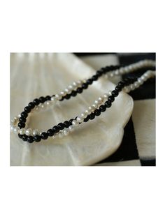 Experience the timeless contrast between black onyx and white pearls with this simple yet striking design. Natural pearls add a soft beauty, while black agate adds a unique charm. This necklace can be DIY by yourself. The two beads are scattered and have a sense of hierarchy. They are twisted together and have a sense of design Metal: 18ct Recycled Gold Plated On Brass Gemstone: Black Onyx Pearl: Freshwater Pearl (4-4.5mm) Length: 360-410mm Weight: 18g Black Pearl Necklace With Round Bead Pendant, Black Pearl Necklace With Pearl Pendant, Black Pearl Necklace With Pearl Charm, Black Pearl Drop Necklace, Black Pearl Necklace With Round Beads And Pearl Drop, Black Pearl Drop Necklace With Round Beads, Black Pearl Pendant Beaded Necklace, Black Beaded Pearl Necklaces With Pearl Pendant, Classic Black Necklace With Pearl Pendant