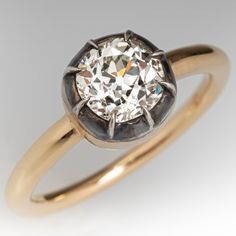 an old mine cut diamond set in a yellow gold engagement ring, circa 1950's