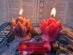 two candles sitting next to each other on top of a table