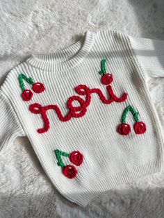 Enjoy a hand embroidered oversized knit sweater with a "cherries over design" This design is perfect for spring/summer or as a keepsake sweater. Oversized fit: meaning the fit is larger/ slouchy and last your child longer. if you want a regular fit please size down or contact me directly  Children's sizing available 0-6m, 6-12m, 12-18m, 18-24m, 2-4T, 5/6 yrs Font: cursive, written the way added to personalization box. Some letters may not connect due to the nature of the name Cherry can be added Cute Red Spring Sweater, Cute Handmade White Sweater, Playful Red Cotton Sweater, Cute White Handmade Sweater, Cute White Embroidered Sweater, Handmade White Cotton Sweater, Playful White Sweater For Spring, Cute White Sweater With Custom Embroidery, White Cute Sweater With Custom Embroidery