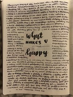 an open book with writing on it and the words what makes love happy written in black ink