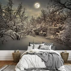 a bed room with a large wall mural on the wall and a night scene in the background