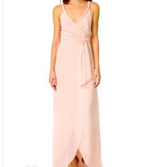 a woman is wearing a pink dress with a slit down the side and an asymmetric