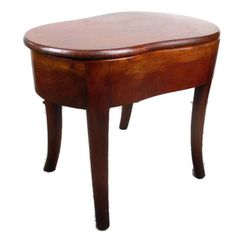 a small wooden table sitting on top of a white background