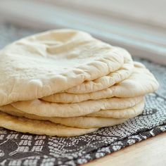 a stack of pita bread sitting on top of a table