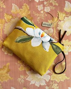 a yellow flowered pouch sitting on top of a table