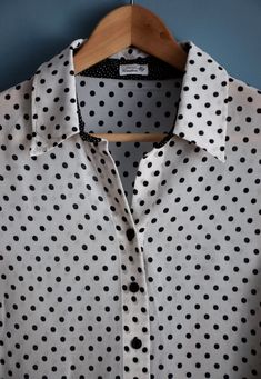 Vintage women's black and white polka dot print blouse, from the 1990s Short sleeve, buttoned blouse with a collar and a black polka dot print on a white background, which on the bottom is contrasted by a white polka dot print on a black background in two differed sizes of the dots. The sleeves have side slits 100% viscose, slightly transparent fabric Size - marked 22 DE , this is the German sizing for shorter women (< 164 cm), corresponds to 44 DE or XL. If you are taller than that, please l Fitted Button-up Blouse With Polka Dot Pattern, Fitted Polka Dot Button-up Blouse, Vintage Polka Dot Blouse For Work, Vintage Polka Dot Blouse For Workwear, Classic Fitted Polka Dot Blouse, Polka Dot Collared Summer Tops, Summer Polka Dot Collared Blouse, Summer Polka Dot Collared Tops, Polka Dot Collared Blouse With Button Closure