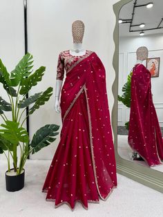 Elevate your ethnic wardrobe with this stunning Red Shimmery Organza Designer Saree, crafted to perfection for the modern woman who appreciates traditional charm with a touch of glamour. This exquisite saree features a rich organza fabric that drapes beautifully and shimmers in the light, making it a standout piece for any special occasion. The saree is adorned with delicate golden embellishments along the border, enhancing the vibrant red color with an elegant finish. The ready-made blouse comes with intricate golden embroidery and can be easily customized to achieve a tailored fit, ensuring you feel both comfortable and glamorous. adding an extra layer of elegance to the timeless red color. complete with a beautifully embellished ready-made golden blouse that offers easy customization to Festive Transitional Saree With Mirror Work, Red Silk Saree With Mirror Work, Red Festive Blouse For Eid, Red Silk Pre-draped Saree With Mirror Work, Festive Georgette Blouse With Zari Work, Red Georgette Blouse For Eid, Designer Red Saree With Mirror Work, Festive Red Georgette Blouse, Transitional Pre-draped Saree With Resham Embroidery For Celebration