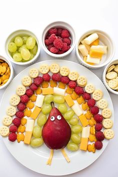 a white plate topped with fruit and crackers