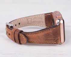 Embrace the art of handmade luxury with our antic brown leather slim Apple Watch band. Meticulously crafted from premium materials, this band offers a unique and stylish way to express your individuality. This luxurious accessory wraps twice around your wrist, adding a touch of elegance and effortless chic to your everyday style. Completely Handmade Genuine Full-Grain Leather Minimalist Slim Design Durable, Stylish & Timeless Design Stainless-Steel Buckles - Secure & Strong Compatible with all A Brown Rectangular Wrist Strap For Watches, Brown Rectangular Watch Strap, Brown Leather Strap Apple Watch Band, Brown Rectangular Watch Accessories With Bracelet Strap, Brown Rectangular Bracelet Strap Watch Accessories, Classic Brown Rectangular Apple Watch Band, Modern Brown Rectangular Apple Watch Band, Brown Handmade Adjustable Watch Band, Handmade Adjustable Brown Watch Band